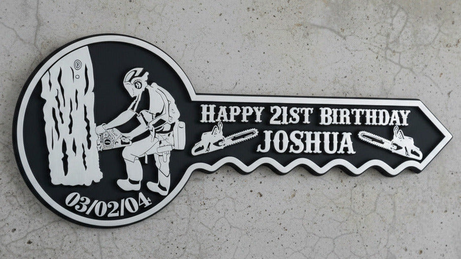 Personalized birthday key-shaped sign with a logger design on a wooden surface